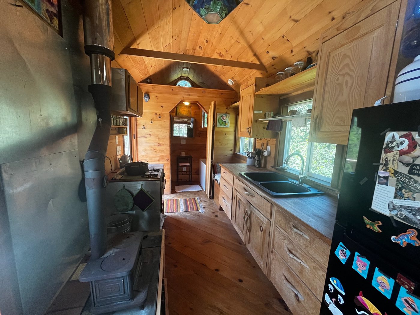 Kitchen with fridge, sink, and tea kettle